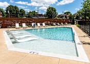 Thumbnail 43 of 47 - a pool with lounge chairs and a fence around it at Grand Flats, St. Louis, Missouri