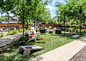 Thumbnail 41 of 47 - a courtyard with benches and grass and trees at Grand Flats, Missouri
