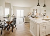 Thumbnail 3 of 19 - an open kitchen and living room with a dining room table and chairs at 44 West Luxury Living, Valley Park, 63088