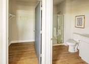 Thumbnail 11 of 19 - a bathroom with a toilet and a shower and a sliding glass door at 44 West Luxury Living, Valley Park, MO, 63088