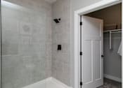 Thumbnail 16 of 36 - A white door is open to a bathroom at The Cunningham Apartments, Apartments, West Des Moines, IA