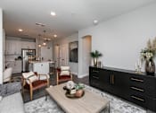 Thumbnail 9 of 36 - A modern living room with a wooden coffee table and a black cabinet. at The Cunningham Apartments, Iowa