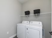 Thumbnail 18 of 36 - A white washer and dryer in a laundry room. at The Cunningham Apartments, Iowa, 50266