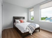 Thumbnail 22 of 39 - bedroom with plank flooring and large windows at Steelcote Square, St. Louis, 63103