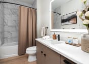 Thumbnail 18 of 58 - a bathroom with a sink and a toilet and a shower at Bemiston Place Apartments, Clayton, MO