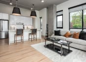 Thumbnail 10 of 58 - a living room with a couch and a coffee table in front of a kitchen at Bemiston Place Apartments, Clayton, MO 63105