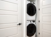 Thumbnail 21 of 58 - a washer and dryer in a closet with white doors at Bemiston Place Apartments, Clayton
