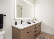Thumbnail 17 of 58 - a bathroom with a sink and a mirror at Bemiston Place Apartments, Clayton, MO 63105
