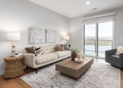 Thumbnail 48 of 71 - a living room with a couch and a coffee table at The Flats & Terraces at Wildhorse Village, Missouri