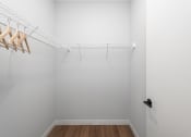 Thumbnail 47 of 71 - an empty closet with white walls and wood flooring at The Flats & Terraces at Wildhorse Village, Chesterfield