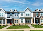Thumbnail 31 of 34 - A row of houses with red and blue doors.