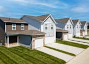 Thumbnail 32 of 34 - A row of houses with garages in front.