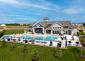 Thumbnail 25 of 34 - A large house with a pool in the backyard.