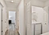 Thumbnail 11 of 33 - A laundry room with a washer and dryer.