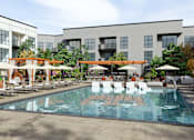 Thumbnail 25 of 28 - Resort-Style Interior Courtyard with Pool, Cabanas, Bocce Ball, Putting Greens, Fire Tables, and Outdoor Kitchen
