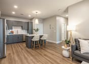Thumbnail 8 of 66 - A modern kitchen with a refrigerator, bar stools, and a dining area.at Preserve at Sycamore Creek, Osage Beach, MO 65065