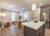 Thumbnail 14 of 66 - A modern kitchen with a white island and stainless steel appliances.at Preserve at Sycamore Creek, Osage Beach, MO 65065