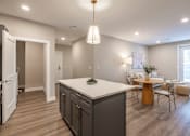 Thumbnail 15 of 66 - A modern kitchen with a large island and a dining area.at Sycamore Creek, Osage Beach, MO 65065