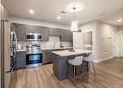 Thumbnail 16 of 66 - A modern kitchen with a large island and stainless steel appliances.at Preserve at Sycamore Creek, Osage Beach, MO