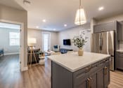 Thumbnail 5 of 66 - A modern kitchen with a large island and stainless steel appliances.at Preserve at Sycamore Creek, Osage Beach, MO