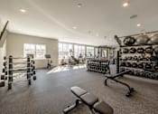 Thumbnail 58 of 66 - A spacious gym with a variety of equipment including weights and machines.at Preserve at Sycamore Creek, Missouri