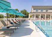 Thumbnail 36 of 66 - A pool area with sun loungers and umbrellas.at Preserve at Sycamore Creek, Missouri 65065