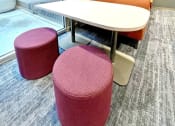 Thumbnail 11 of 17 - clubroom/resident lounge small work/study area with bench, table and modular seating  at The Residences at Delmar DivINe, St Louis, Missouri