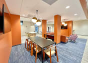 Thumbnail 9 of 17 - clubroom/resident lounge with large work table  at The Residences at Delmar DivINe, St Louis