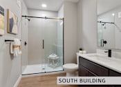 Thumbnail 13 of 21 - a bathroom with a toilet sink and shower  at Expo at Forest Park, St. Louis, MO