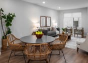 Thumbnail 58 of 71 - a living room with a table and chairs and a couch at The Flats & Terraces at Wildhorse Village, Chesterfield, 63005