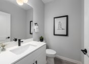 Thumbnail 65 of 71 - an empty bathroom with a sink and a toilet at The Flats & Terraces at Wildhorse Village, Chesterfield