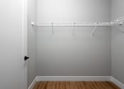 Thumbnail 15 of 18 - A white closet with a shelf and a black door handle.