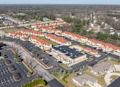 Thumbnail 40 of 45 - A large building complex with a parking lot in front.