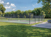 Thumbnail 11 of 22 - a pickleball court with a fence around it on a grass field at Timber Club, St. Peters, MO