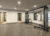Thumbnail 16 of 22 - A gym with a grey floor and white walls.