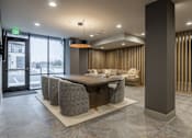 Thumbnail 17 of 22 - A modern office lobby with a reception desk and chairs.