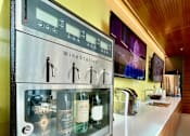 Thumbnail 19 of 42 - A wine cooler with several bottles of wine inside.