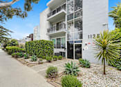 Thumbnail 2 of 2 - A white building with the number 1128 on it.