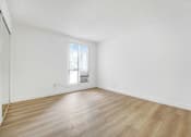 Thumbnail 5 of 12 - A room with wooden flooring and a window with blinds.