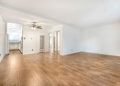 Thumbnail 2 of 9 - A room with wooden flooring and a ceiling fan.