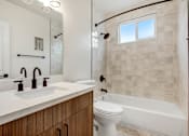 Thumbnail 8 of 11 - A white sink with two bronze faucets on a marble countertop.
