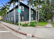 Thumbnail 11 of 11 - A green building with a bicycle sign on the front.