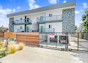 Thumbnail 9 of 31 - A modern two-story house with a balcony and a fence.