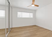 Thumbnail 7 of 12 - A room with a ceiling fan and a window with blinds.