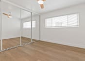 Thumbnail 8 of 12 - A room with a ceiling fan and a glass wall.