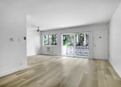 Thumbnail 2 of 35 - A room with wooden flooring and a ceiling fan.