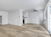 Thumbnail 6 of 35 - A room with wooden flooring and a ceiling fan.