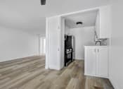 Thumbnail 10 of 35 - A kitchen with a white cabinet and a black oven.
