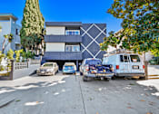Thumbnail 20 of 35 - A modern house with a white and black exterior and a white van parked in front.