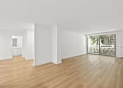 Thumbnail 41 of 56 - A room with wooden floors and white walls.